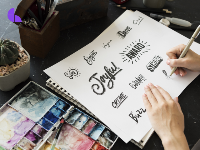 A graphic designer sketching typography/caligraphy types.
